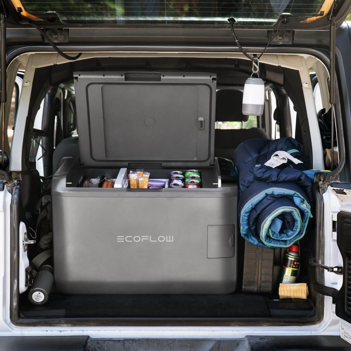 EcoFlow Glacier mobile compressor fridge in a camper, ideal for camping trips with cool drinks and supplies.